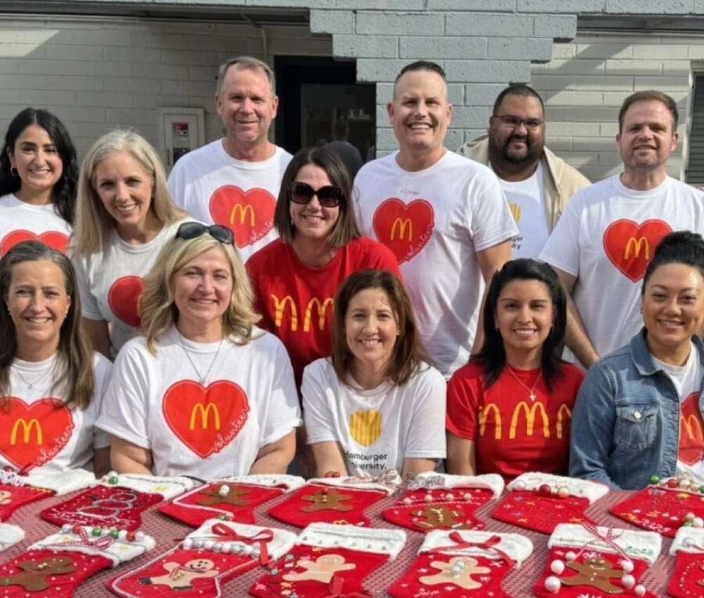 group of volunteers gathered to decorate stockings for our houseguests