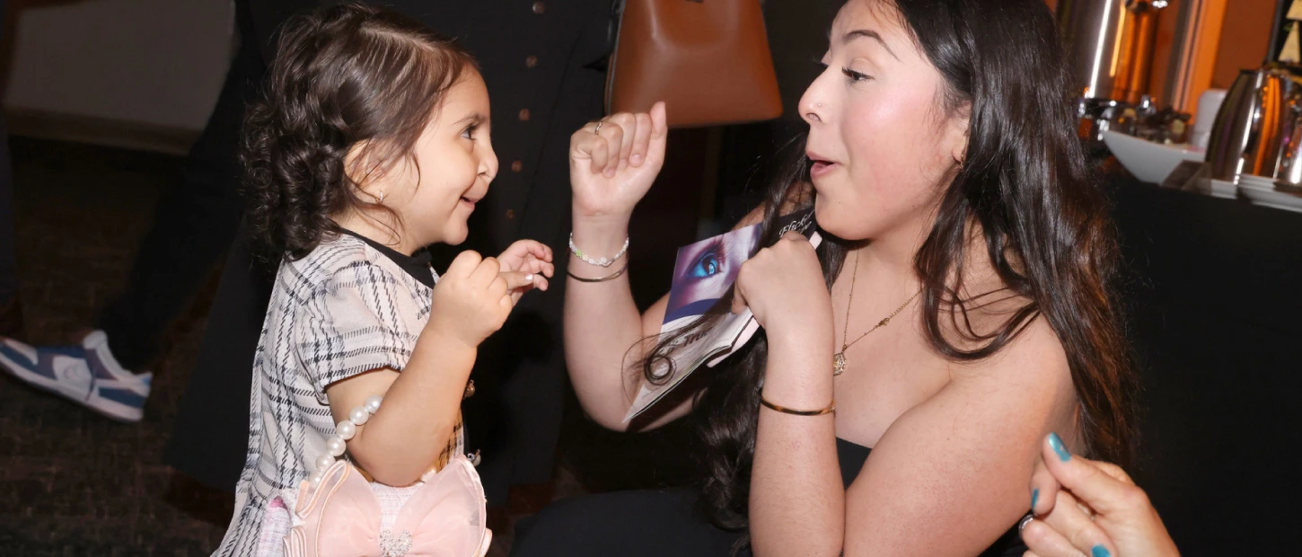 gala attendee dancing with young girl