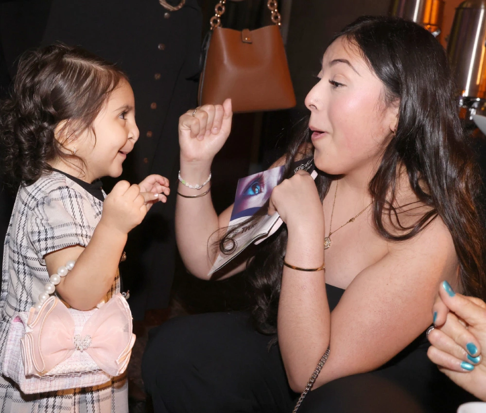gala attendee dancing with young girl
