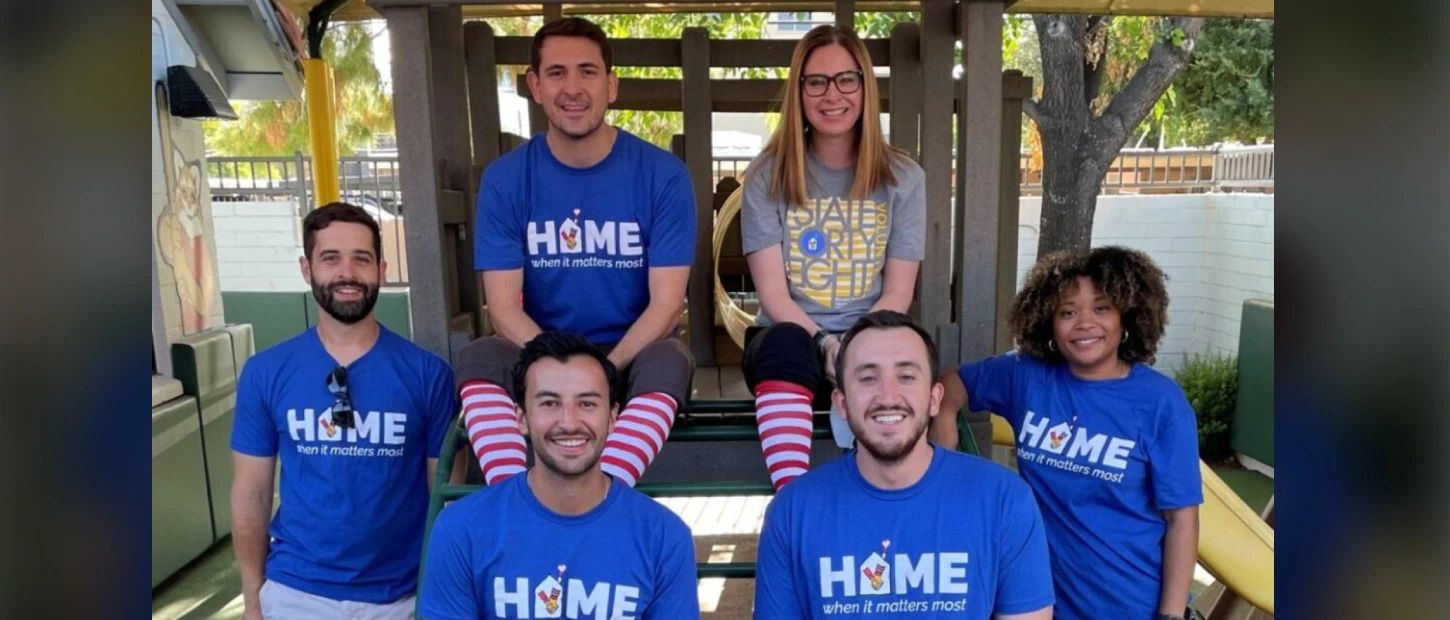 members of the red shoe society wearing matching shirts at event